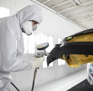 Collision Center Technician Painting a Vehicle | Toyota of Greensburg in Greensburg PA